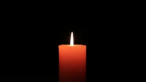 Closeup candle burning in a dark Stock Footage 143650278