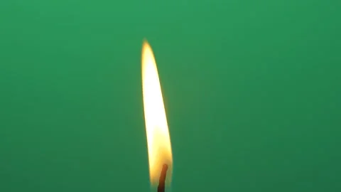 Closeup candle fire flame burning on chroma key green screen background 4K video Stock Footage 147423174