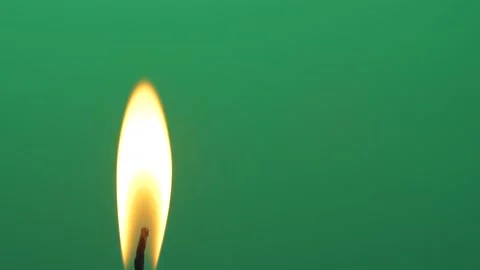 Closeup candle fire flame burning on chroma key green screen background 4K video Stock Footage 151303773