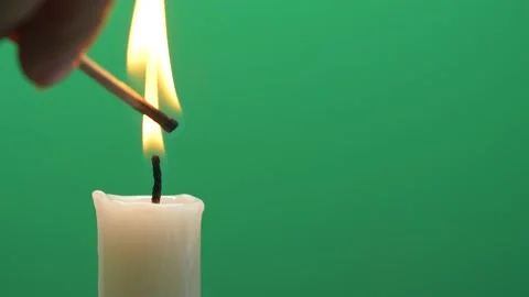 Closeup candle flame igniting and burning on chroma key green screen background Stock Footage 151810889