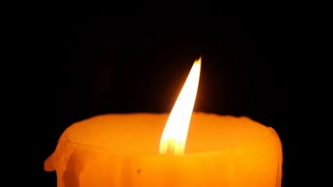 Closeup on candle flame light on black background Stock Footage 101841834