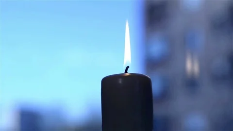 Closeup of candle lit rotating by the window at evening Stock Footage 71486354