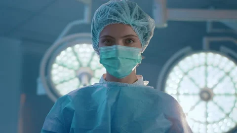 Closeup capturing video of a surgeon assistant at woman in the operation room Stock Footage 209992151