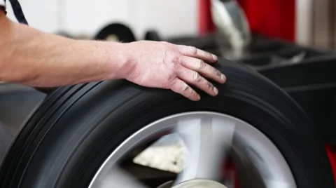 Closeup of car mechanic checking tire on balancing machine Video stock 54234534