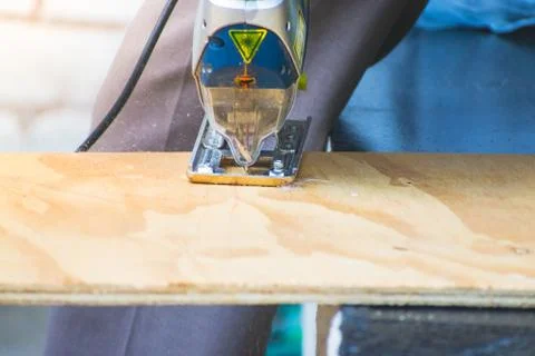 Closeup of Carpenter using circular saw for cutting wood building products Stock Photos