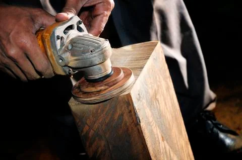 Closeup of carpenter using power wood sander Stock Photos
