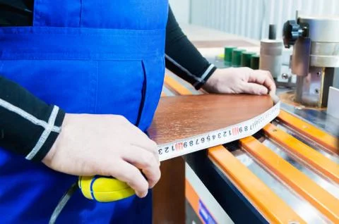 Closeup of Carpenter's hands using one meter in a cottage workshop Stock Photos