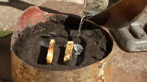 Closeup of casting lead in sand mold slow motion Stock Footage 8567759