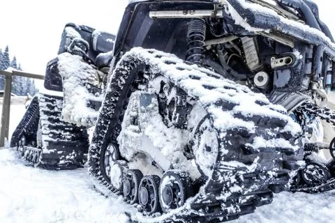 Closeup of a caterpillar snowmobile with snow Stock Photos