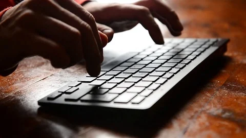 Closeup of caucasian hands typing fast on black keyword on wooden desk 스톡 동영상 122968478