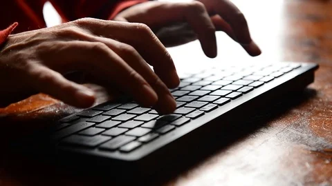 Closeup of caucasian man hands typing on black keyword on wooden desk 스톡 동영상 122969917