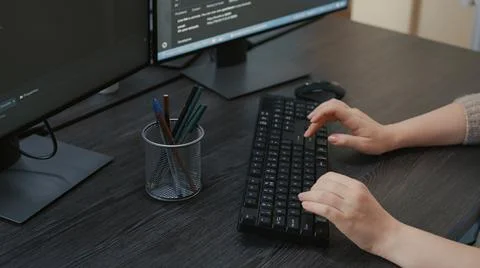 Closeup of caucasian programer hands typing code on keyboard in front of Foto stock