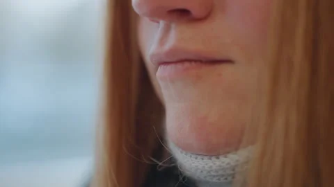 Closeup caucasian redhead lower face contemplative commuter by window, knit Stock Footage 332044152