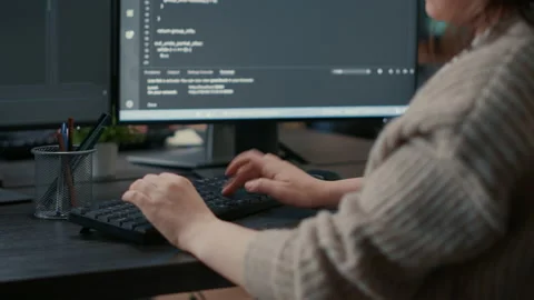 Closeup of caucasian software coder hands typing on keyboard in front of Stock Footage 168235393