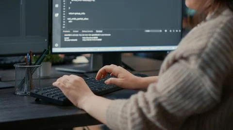 Closeup of caucasian software coder hands typing on keyboard in front of Foto stock