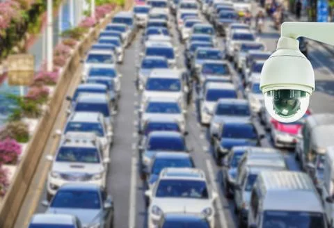 Closeup of CCTV security camera on abstract Blurred photo of traffic jam Stock Photos