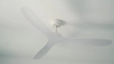 Closeup of Ceiling fan in a room with white walls Stock Footage 277115746