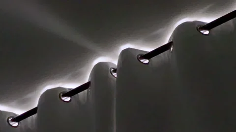 Closeup of ceiling light patterns through curtain tops Stock Footage 314892615