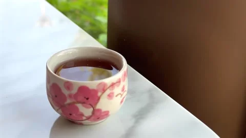Closeup ceramic cup of hot tea on the table Stock Footage 306128553
