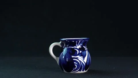 Closeup of a ceramic Talavera cup isolated on a black background Stock Footage 149207661