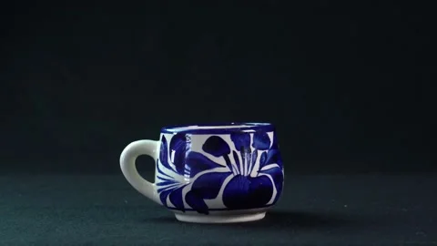 Closeup of a ceramic Talavera cup isolated on a black background Stock Footage 149207672