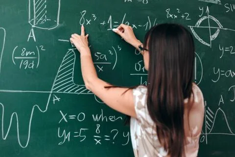 Closeup a chalkboard. Teacher pointing to the example and explain a lesson.-  Stock Photos