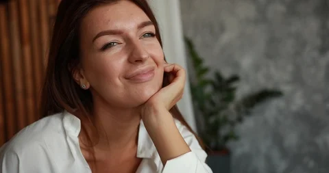 Closeup of charming woman's face smiling tender and dreaming about something Stock Footage 96875796