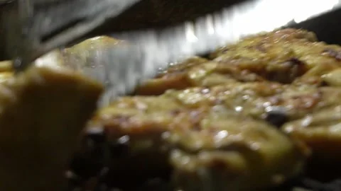 Closeup checking grilled chicken wings for doneness by flipping them with tongs 스톡 동영상 194502272