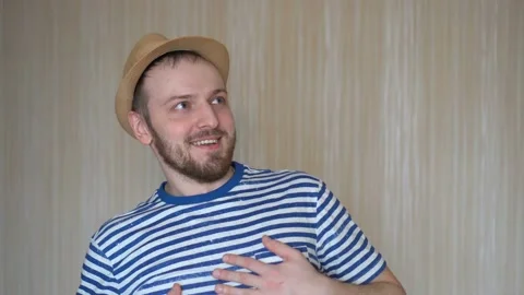 Closeup of cheerful young man in hat standing and smiling Stock Footage 103131789