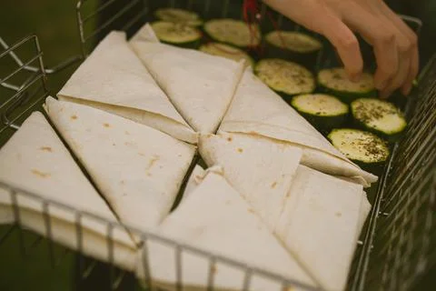 Closeup of cheese warp on triangle shape and small slices of fried Zucchini Stock Photos