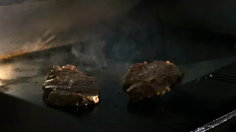 Closeup chef cooks steaks on the grill. Video stock 119094753