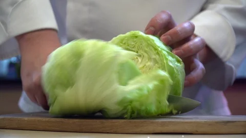 Closeup of chef cutting cabbage on the wooden board Stock Footage 77039729