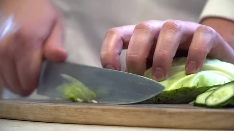 Closeup of the chef cutting cucumber Stock Footage 77039217