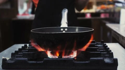 Closeup of chef with empty wok pan and fire. Preparing chef. Stock Footage 221124761