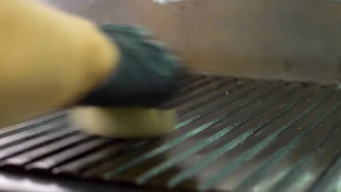 Closeup of chef hand in glove greasing big professional grill stove with onion Stock Footage 113519393