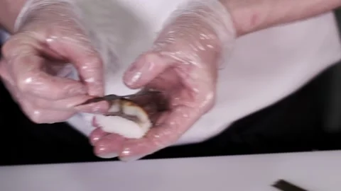 Closeup of the chef hands in gloves makes Japanese sushi rolls. Slow motion Stock Footage 133654434