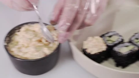 Closeup of the chef hands in gloves making japanese sushi rolls. Seafood Stock Footage 133654614