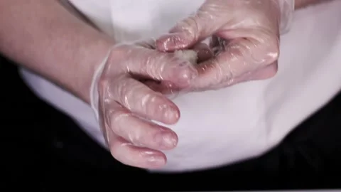 Closeup of the chef hands in gloves making japanese sushi rolls. Slow motion Stock Footage 133654888