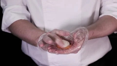 Closeup of the chef hands in gloves making japanese sushi rolls. Slow motion Stock Footage 133654904