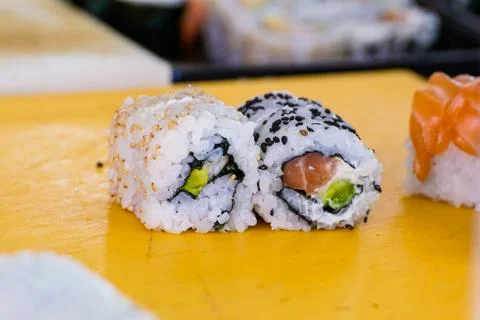 Closeup of chef hands preparing japanese food. making sushi at restaurant. Stock Photos