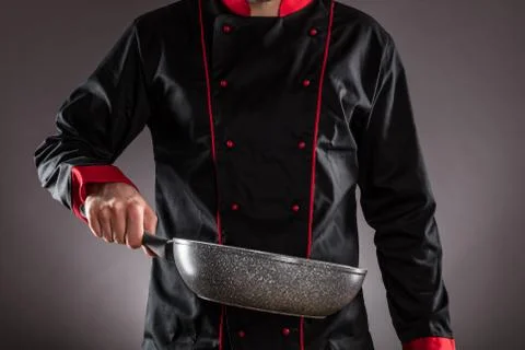 Closeup of chef holding empty frying pan Stock Photos