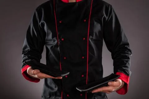 Closeup of chef holding empty plates. Stockfoto's