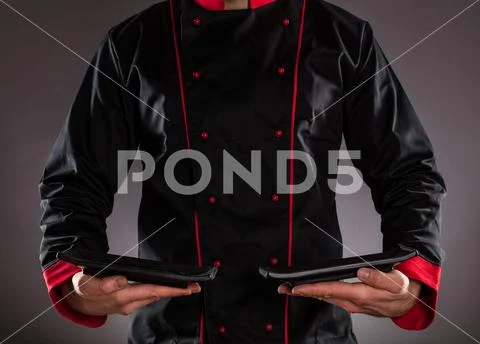 Closeup of chef holding empty plates. Stock Photos