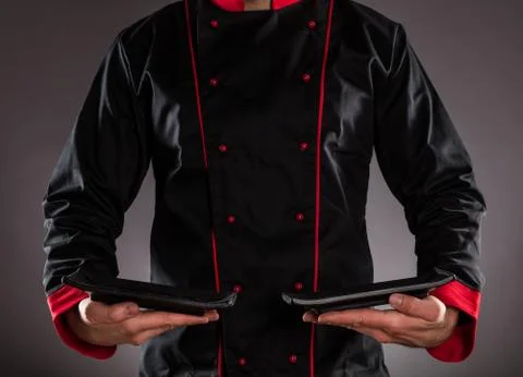 Closeup of chef holding empty plates. Stock Photos