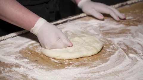Closeup of chef making khachapuri on the kitchen table on flour Stock Footage 73622491