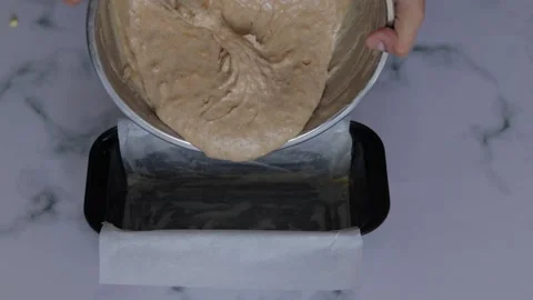 Closeup of chef pouring cake batter into rectangular pan Stock Footage 139260113