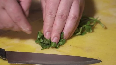 CLoseup of chef's hands chopping fresh dill Stock Footage 73622801