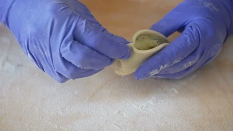 Closeup of chef's hands making and folding sardinian ravioli filled pasta Stock Footage 128707693