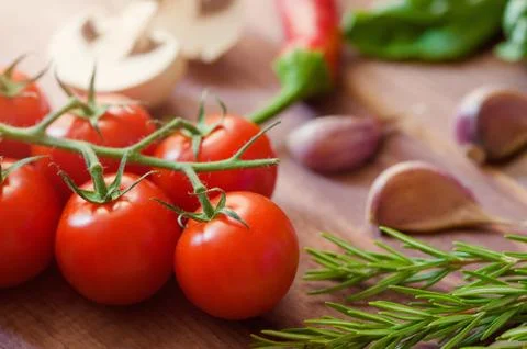 Closeup of cherry tomatoes on the vine And other vegetables Stock Photos