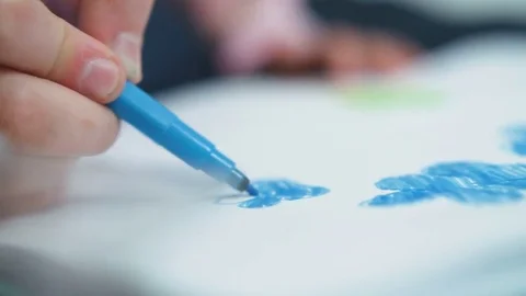Closeup child hand draws a blue marker Stock Footage 78214620